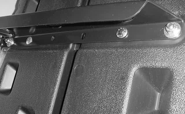 holes on the cargo tray. Install the 5/16 carriage bolts upward through the bottom of existing bracket and Cargo Tray.