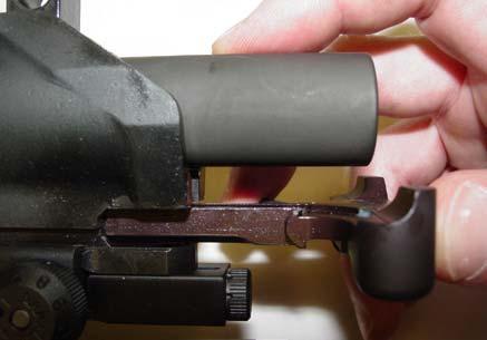 Pull the charging handle back and down to remove
