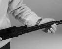 5. While holding the action bar with your left hand to counterbalance the thrust of the recoil spring, push the carrier release button (Fig.