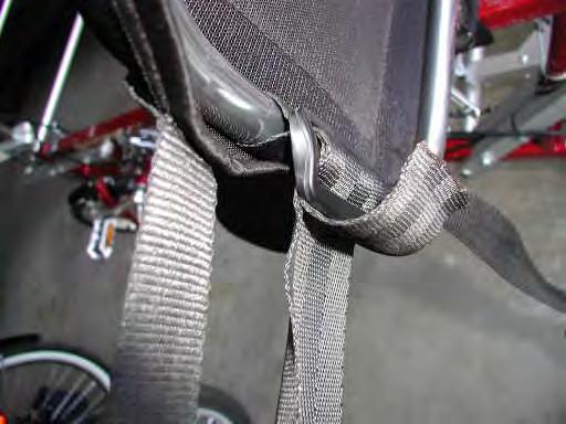 22) Insert the end of nylon strap back through the tri-glide as shown in figure 22. Reconnect the middle two seat back mounting buckles on the EZ-1 seat.