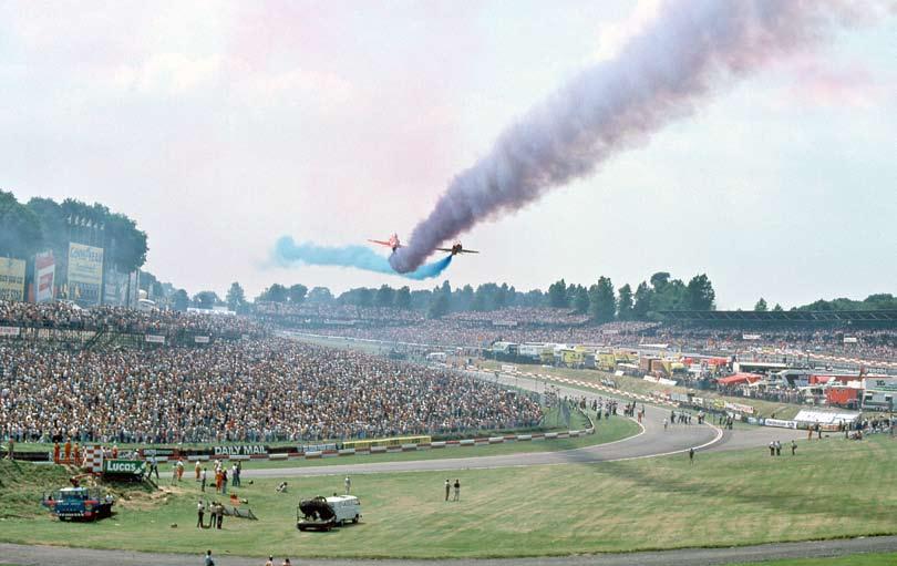 One of the features of a Grand Prix at Brands Hatch in the eighties was the spectacular air displays. Here, the Red Arrows Synchro Pair pass each other over the natural bowl of the circuit.