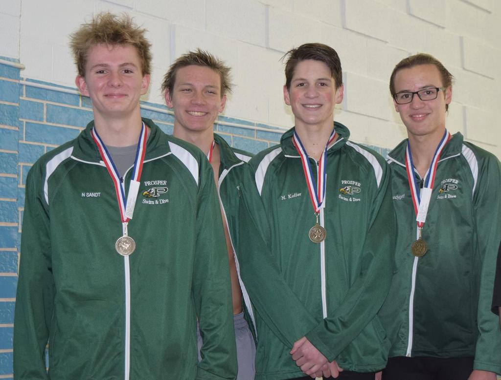 The boys 200-yard Medley Relay team receive their first place medals.