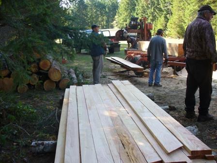 Left: Stacking the lumber as it comes off the sawmilling machine Centre: Lumber is stacked