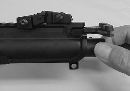 Depress the take down pin located just above and to the rear of the safety/selector on the left side of the receiver. 7.