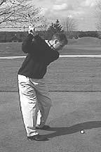 From the rear view, the club should be parallel to the target line with both hands under the shaft for support.
