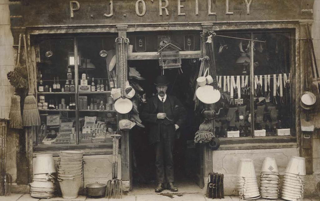 Patrick O Reilly (P. J.) standing in the doorway of his shop on Main St.