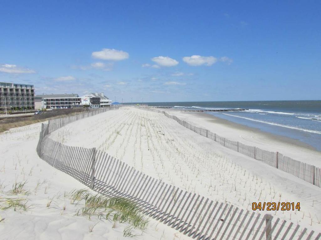 The beach berm elevation has been lowered and the width landward nearly 200 feet following the project but the beach width prevented major dune erosion and allowed continued vehicle access to the