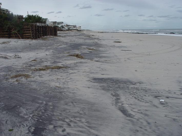It is evident in the photographs that the existing dune was completely eroded away and overwash occurred, with waves pushing water and sand under the oceanfront homes and into the streets landward of