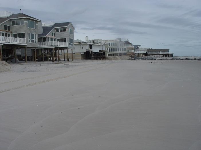 It is evident in the photographs that the existing dune was completely eroded away and overwash occurred, with waves pushing water and sand under the oceanfront homes and into the streets