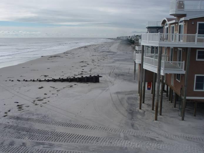 It is evident in the photographs that the existing dune was completely eroded away and overwash occurred, with waves pushing water and sand under the oceanfront homes and into the streets landward of
