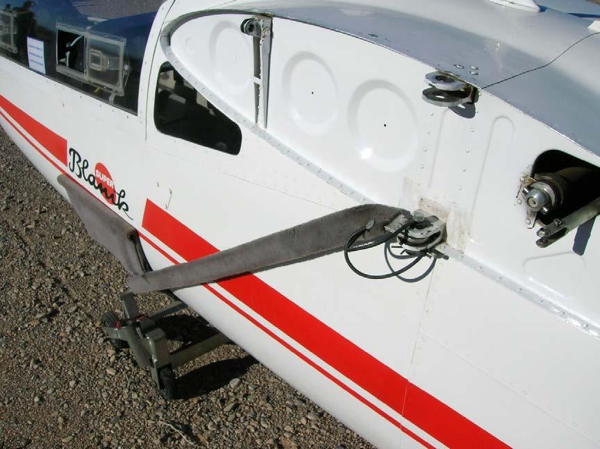 cradle (if any) utilizing the wing attachment points so it will not interfere with the wing installation, but do NOT remove the cradle or device stabilizing the fuselage at this time.