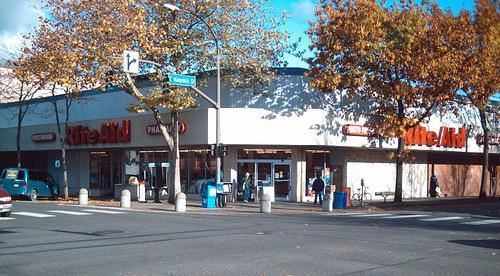 Clear pedestrian route & remodel intersection corners; mature trees Central location Large building, hot dog stand Colorful benches and banners, remove/replace awning, fix lighting, add window.
