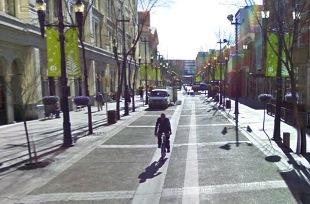 Vehicles, cyclists and cars intermix on Stephen Avenue in Calgary Introduction of street