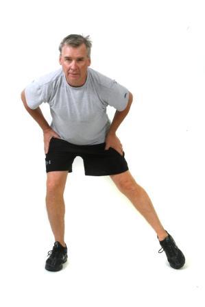 Squat with Side Tap Start: Stand with feet slightly wider than hip-width and knees bent in a slight
