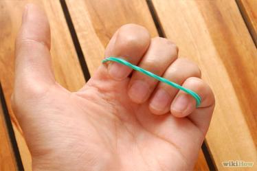 4 Put the ends of all four fingers in the rubber band (your pointer, middle,