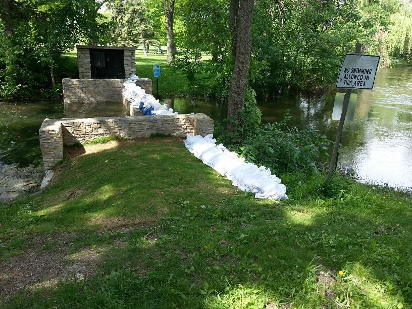 As the creek continued to rise with more storms, additional sandbags were needed in the parkland around the weir structure