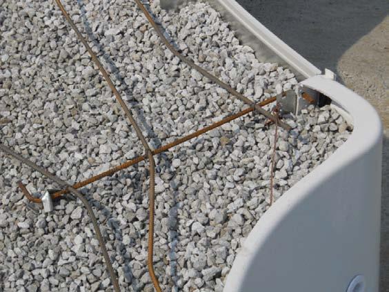 Photo B4 Pool reinforcing bracket that is pressure fitted Photo B5 A conductive mesh below the deck in solid contact with the pool (b) Bonding for pool equipment Rule
