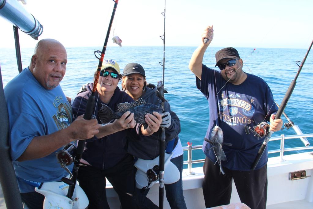 Mr. Terry Hill, Captain Kathy Brown, Diane Hill, and Terry Hill Jr are showing us just a few of the black sea bass that they caught while plain old bottom