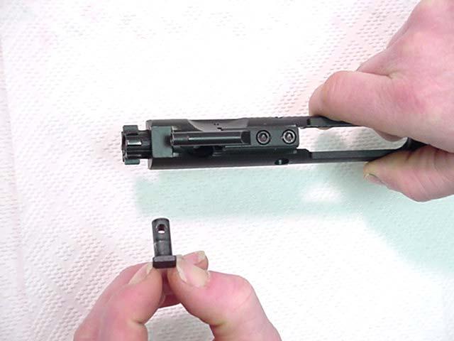 6. Catch the firing pin (5) as it drops out of the rear of the bolt carrier assembly ().