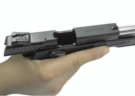 You may remove the magazine and reload the magazine while the slide is locked open by the slide stop.