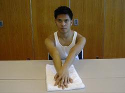 Two Arm Towel Stretch Shoulder Flexion 1. Sit at a table. Put a towel in front of you. 2.