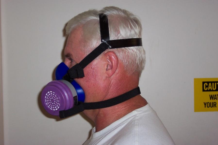 A properly donned Survivair 2000 dual cartridge half mask facepiece. To be properly donned, the respirator must be correctly oriented on the face and held in position with both straps.