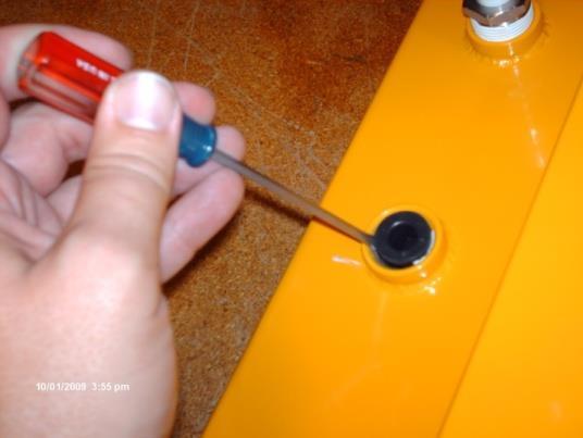 Using a small screw driver, pry