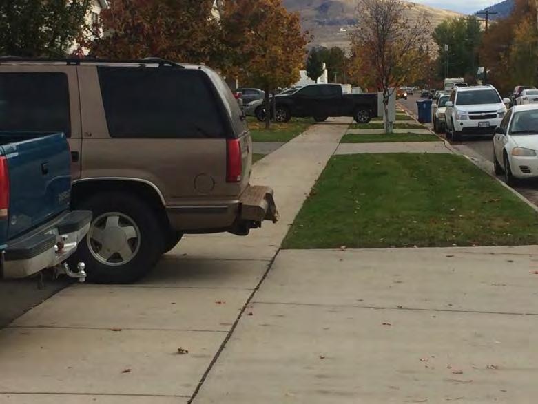 Parked vehicles obstructing sidewalk Cause believed to be inadequate