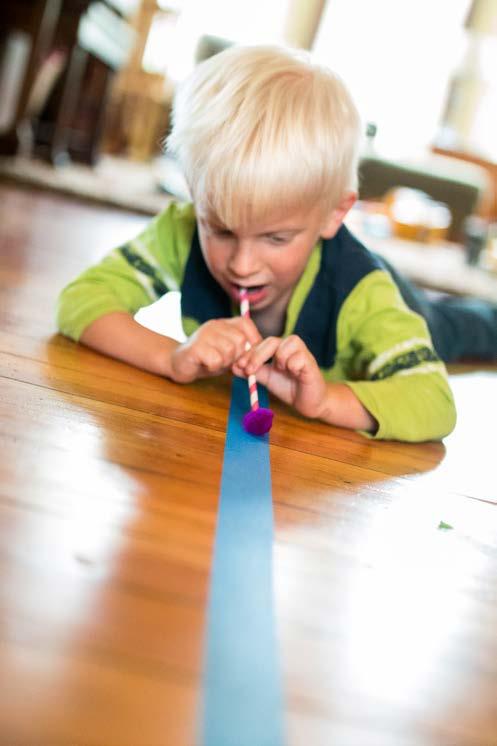 Blow a pom pom along the line, gently trying to keep it on the line of tape. Young kids and old, love this activity. Its great for balance and coordination.
