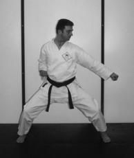 9) Cross the right ankle in front of left ankle. 10-11) As the step is completed, raise the left knee and stamp down fumikomi.