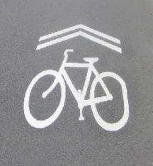 The symbols are designed to indicate to cyclists the location of the bike lane.
