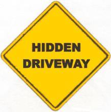 7.4 Hidden Driveway Signs The Hidden Driveway sign is a warning sign which may be erected in advance of private driveways with restricted stopping sight distance causing an unusual degree of hazard.