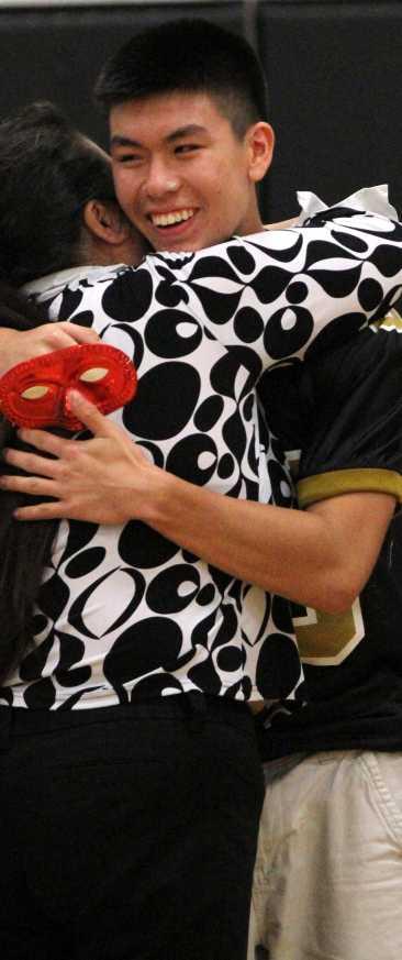 Senior Austin Show hugs his mom during the homecoming pep rally after being tricked by the cheerleaders.