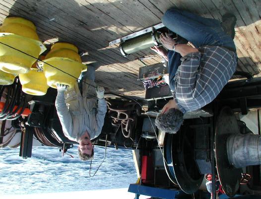 Jeff Nystuen and Eric Boget attaching an Acoustic Rain Gauge (ARG) to the mooring line.