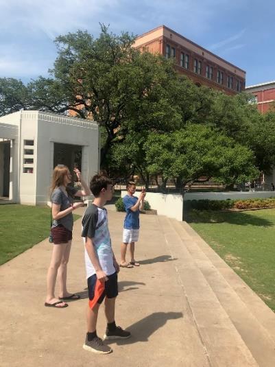 In the background of the photo to the left is the Texas School Book Depository, where Oswald shot JFK from the 6 th story window.