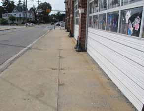 The sidewalk can wrap around the driveway ramp if needed to remain level, however this presents a challenge for those who have visual impairments.