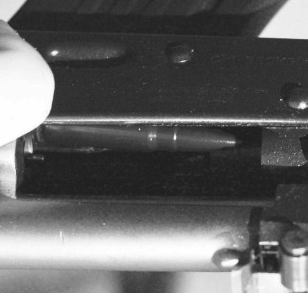 Insert the front of the magazine into the magazine well. (See Illustration #6.) 4. Rotate the magazine rearward until it engages the latch.