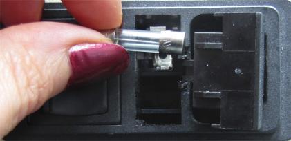 There is a catch to keep the housing from coming completely out (Fig. 10). Fig. 10- Open the fuse housing and rotate it right to remove the fuse. 5. Remove the bad fuse.
