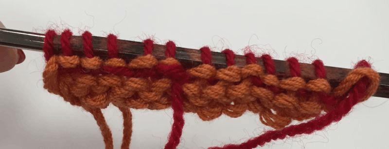 Be sure not to knit the tail with the working yarn. Step 2: Note that the tail is held in place by the index in middle figures. (See Figure 2.