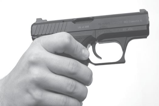 PRESS MAGAZINE CATCH DOWN t To lock the slide to the rear, press the slide catch lever rearward with either the forefinger or thumb of the shooting hand