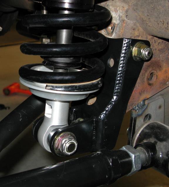 The upper coilover mount should fit the contour of the vehicle in front of the factory coil spring perch.