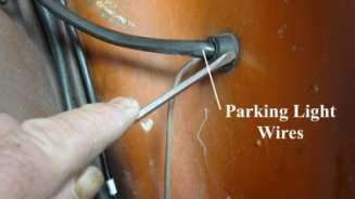 794. Depress the grommet with a small flathead screwdriver and push the parking