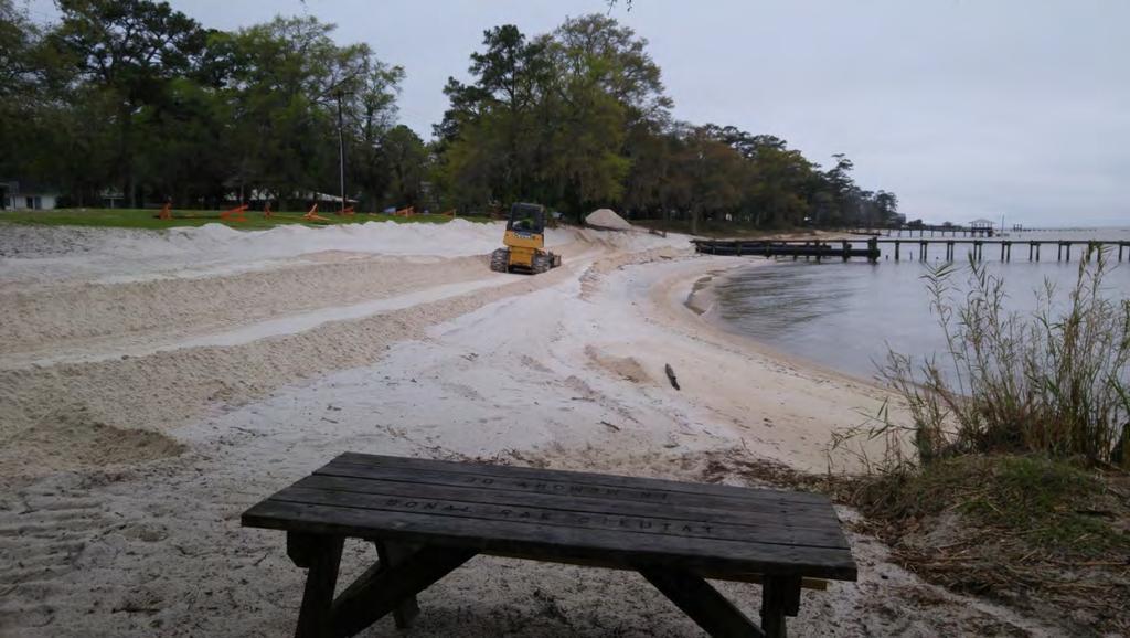 deposit similar to the white sands of the beaches of Gulf Shores. Trucks haul the sand to the beach site where it is spread along the beach as shown in Figure 6.