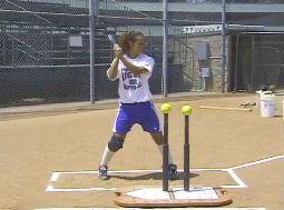 a. Face the batter at a batting tee, on the other side of home plate, while holding a batting stick.