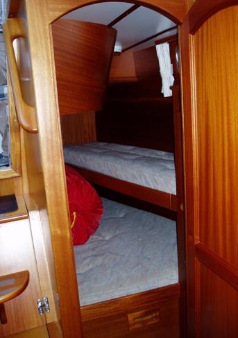 Large drawers underneath berth Forward en-suite heads compartment Sea toilet and stainless steel holding tank Basin with