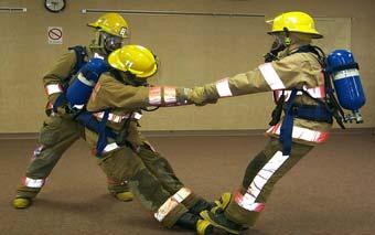 The rescuer holding the victim s wrists pulls them to a sitting position; the other rescuer assists by gently pushing on the victim s back The rescuer holding the head reaches under the victim s arms