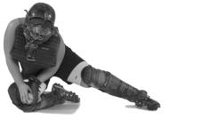 With the back side of the glove on the ground, the catcher places the glove between the legs to execute the block.