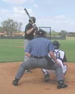 The umpire then goes into the stance. This is a gauge to assure the umpire proper placement of the body to see the outside corner.