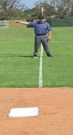 above) straddling the foul line when making your decision. Stand up pointing to fair territory with the arm closest to fair territory.