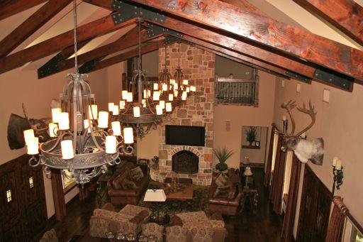 There is an exquisite great room complete with exposed beam rafters, eight-seat bar with a 42 flat-screen TV, and large